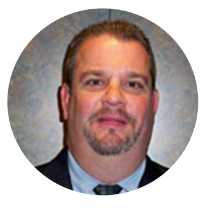 Headshot of Kentucky Farmers Bank Board Member. He is smirking and wearing a suit and tie